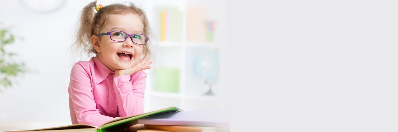 Young Child Reading while Wearing Glasses