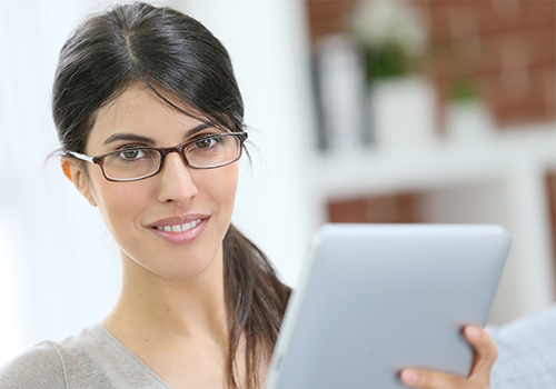 Professional Woman Wearing New Glasses while Working