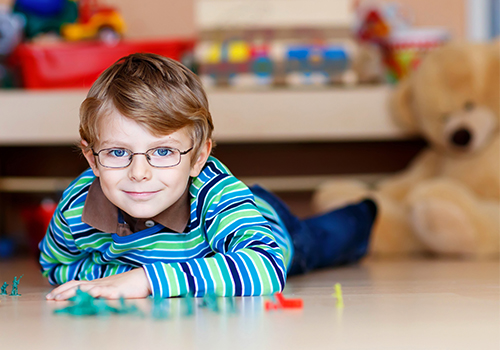 Young Child Playing while Wearing Glasses